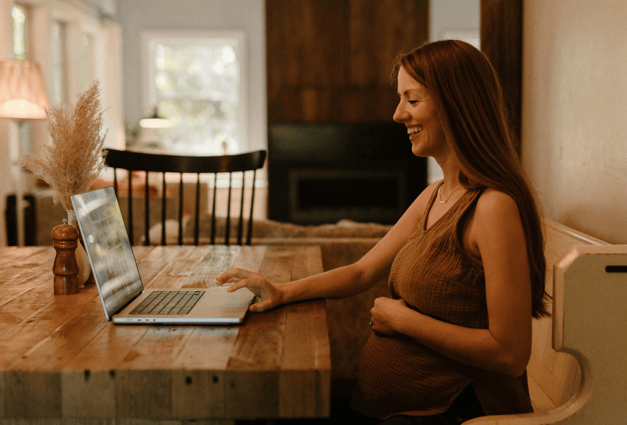 Pregnant woman using laptop on ColsonFellows.org